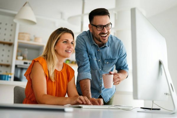 Couple smiling at computer screen